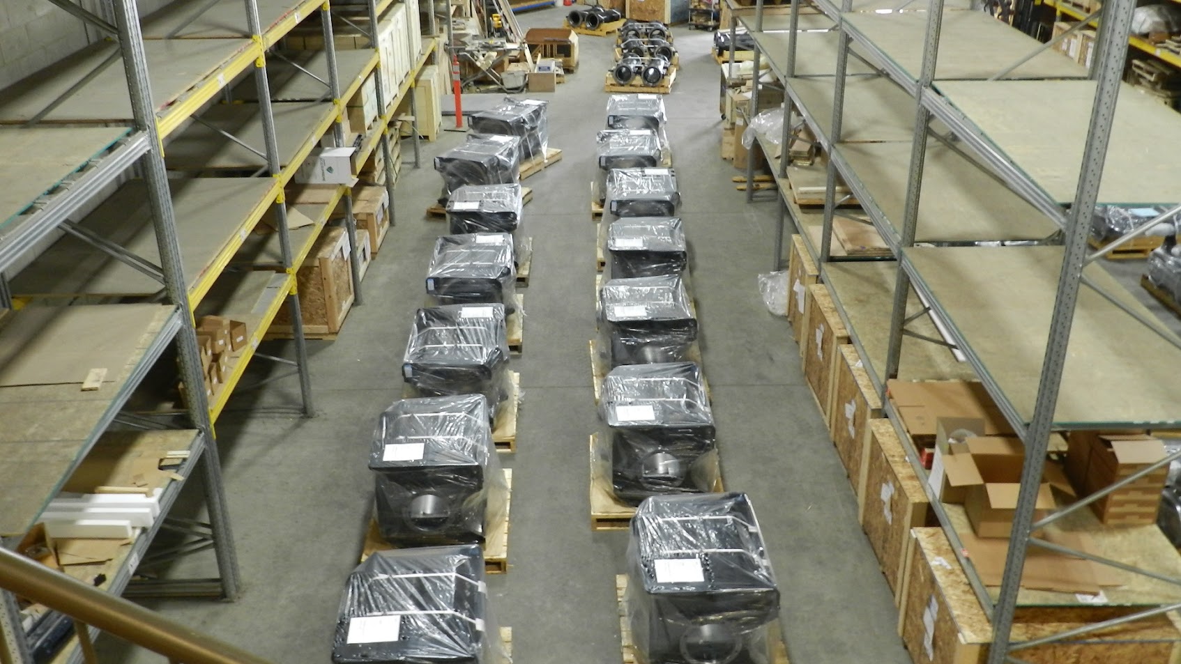 Overhead — wrapped traction motors and components in warehouse staging area